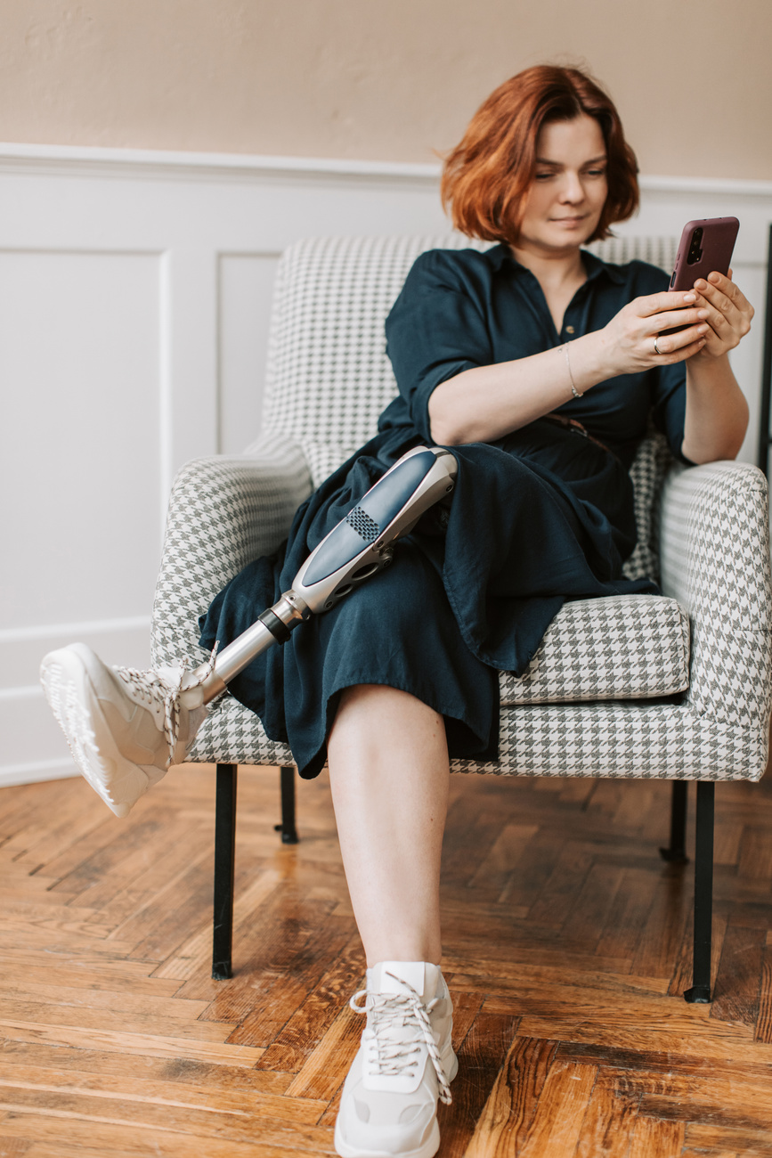 Woman sitting on an Armchair using Phone 