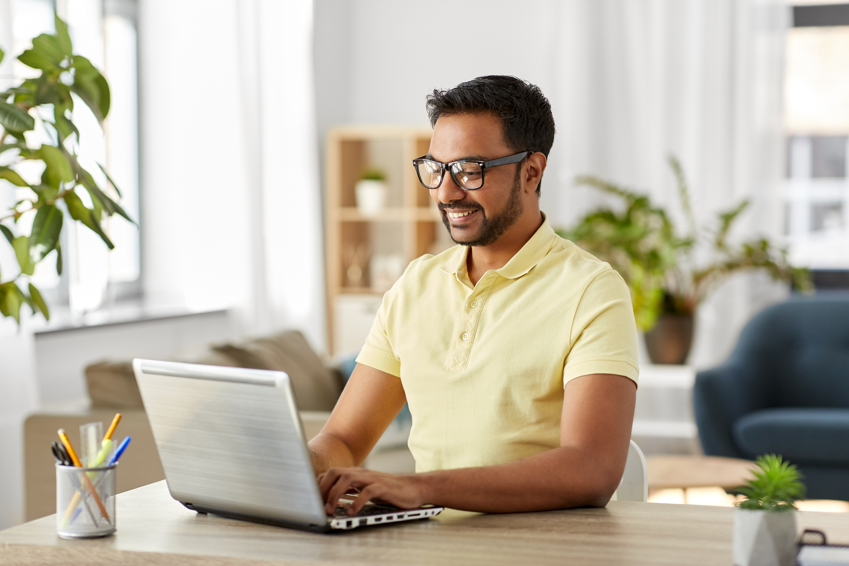 Indian Man with Laptop Working at Home Office